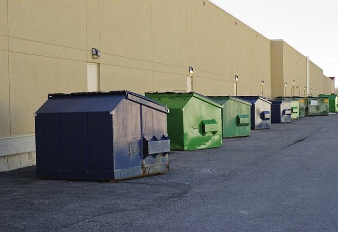 a construction worker moves construction materials near a dumpster in Aliquippa, PA