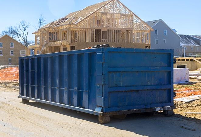 an industrial dumpster with a lid full of construction debris